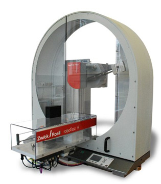 roboTest H pendulum impact tester with automated specimen loading cartridge.