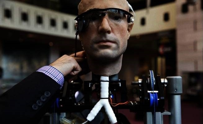 An engineer makes an adjustment to the robot "The Incredible Bionic Man" at the Smithsonian National Air and Space Museum in Washington