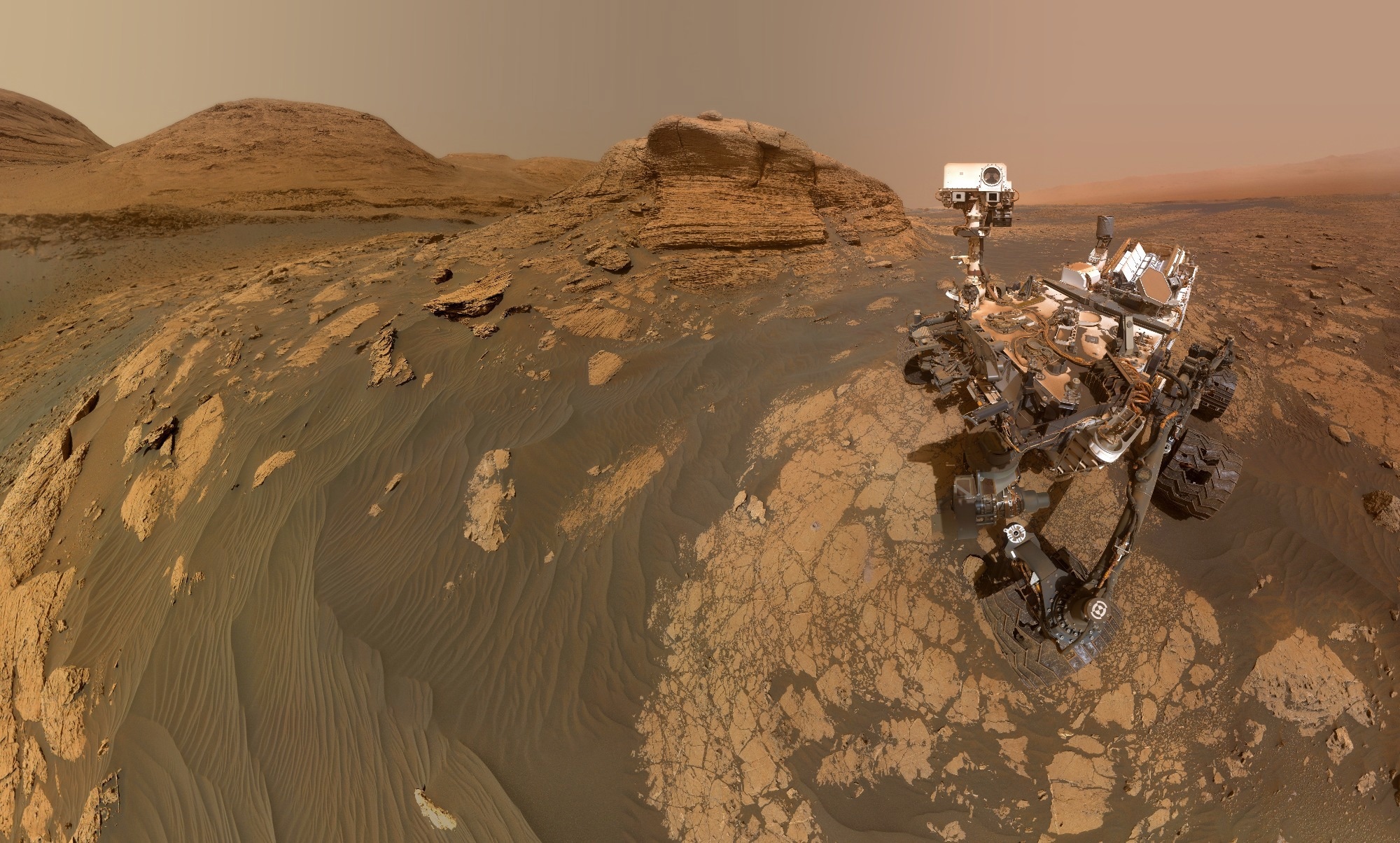 NASA’s Curiosity Mars rover on Mars surface with Mont Mercou. Elements of this image furnished by NASA.