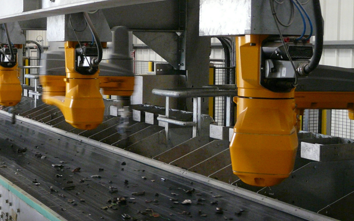 Image left: The single parts, with weights from 20 g up to 1 kg, are sorted into soft containers. Image right: All in a row: In the Megapicker line, 18 Stäubli robots are employed to sort precious non-ferrous shredded parts from car recycling