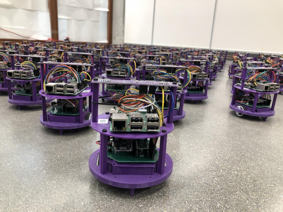 One hundred small robots line up in the laboratory