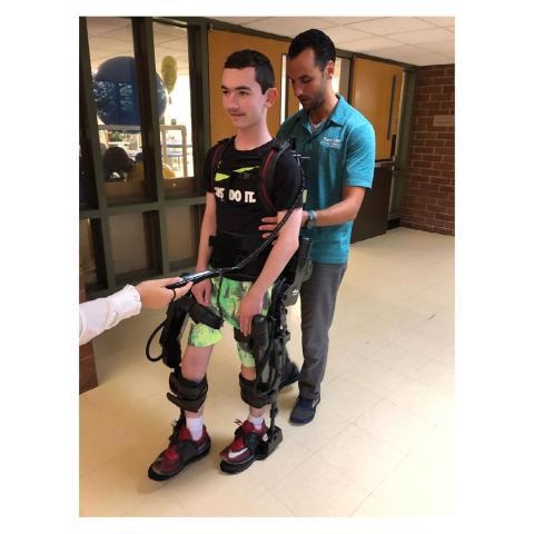 A study participant undergoing gait training in the EksoGT administered by a licensed physical therapist.