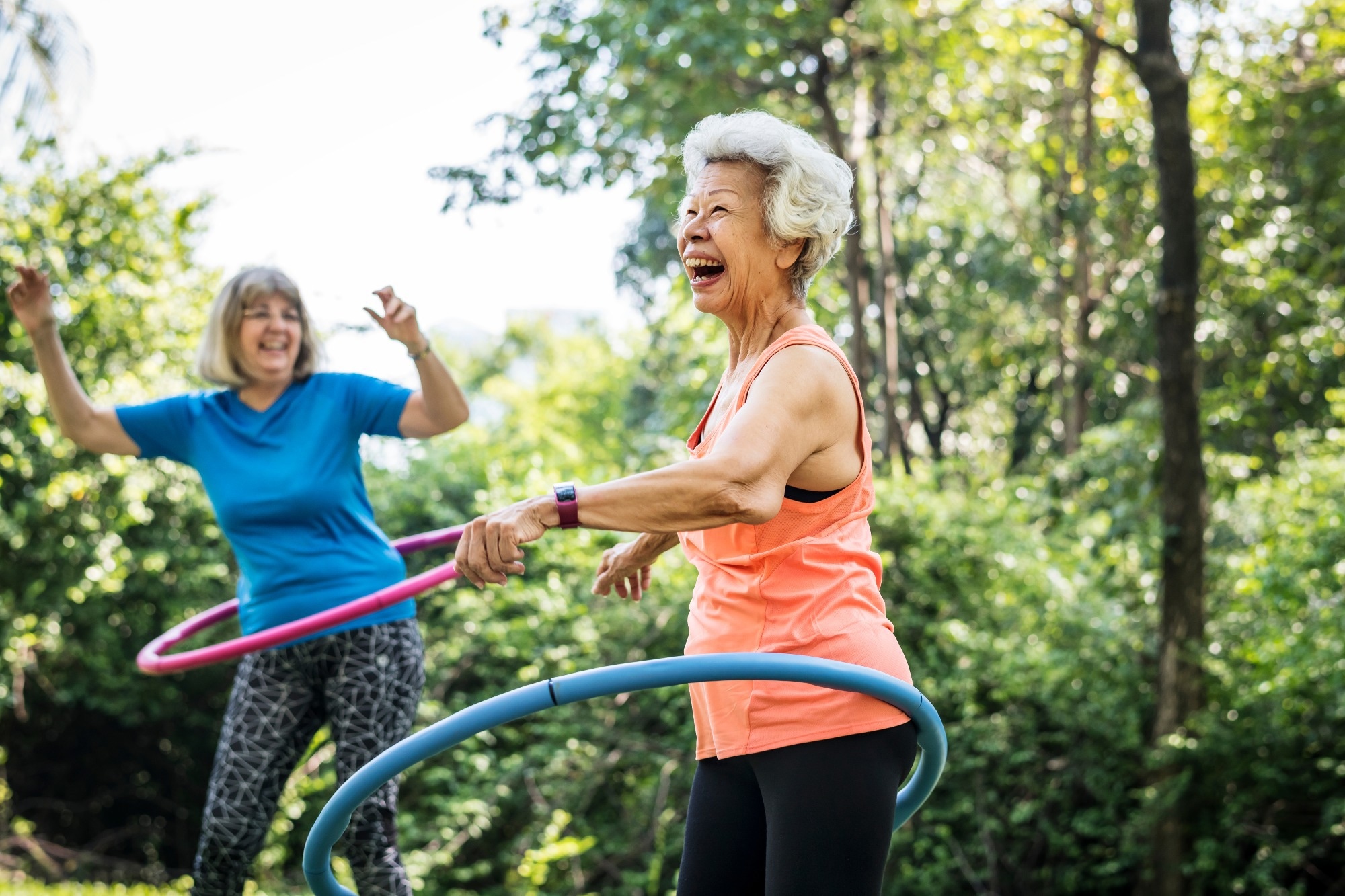 Senior woman exercising with a hula hoop.