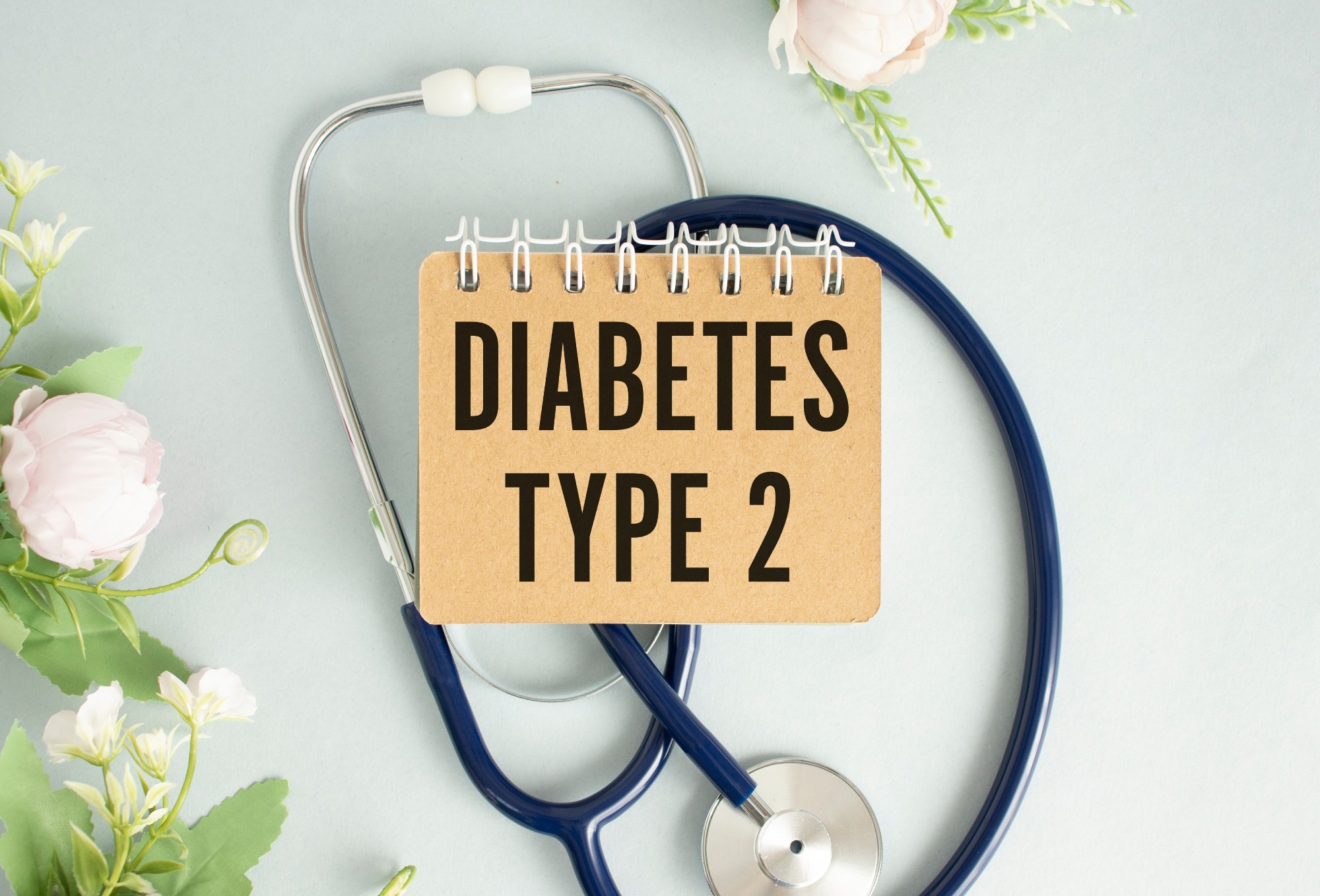 DIABETES TYPE 2 written on a clipboard.
