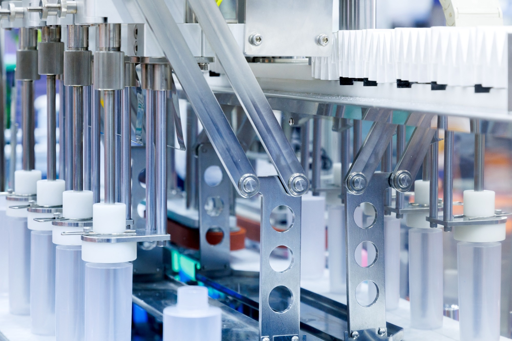 Robotic arm moving plastic bottle to conveyor belt