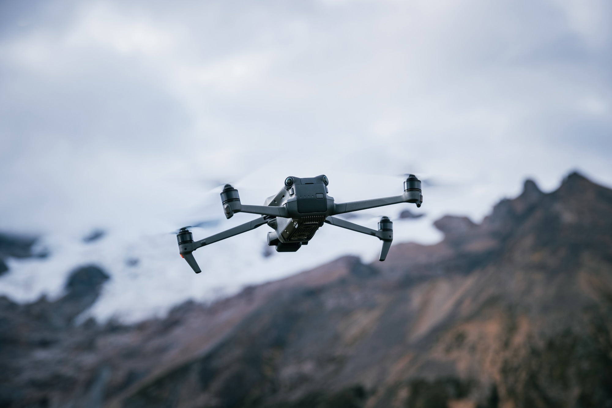 Drone flying on high altitude mountain top.