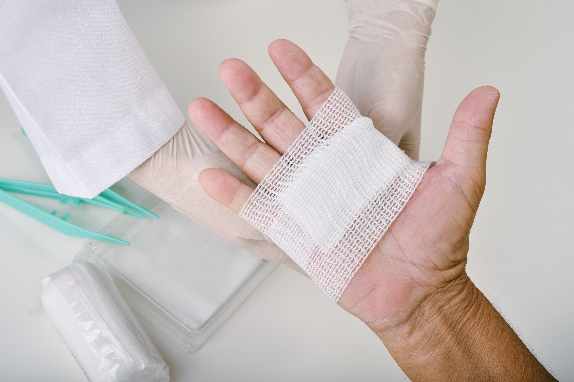 Doctor doing wound dressing care and bandaging patient