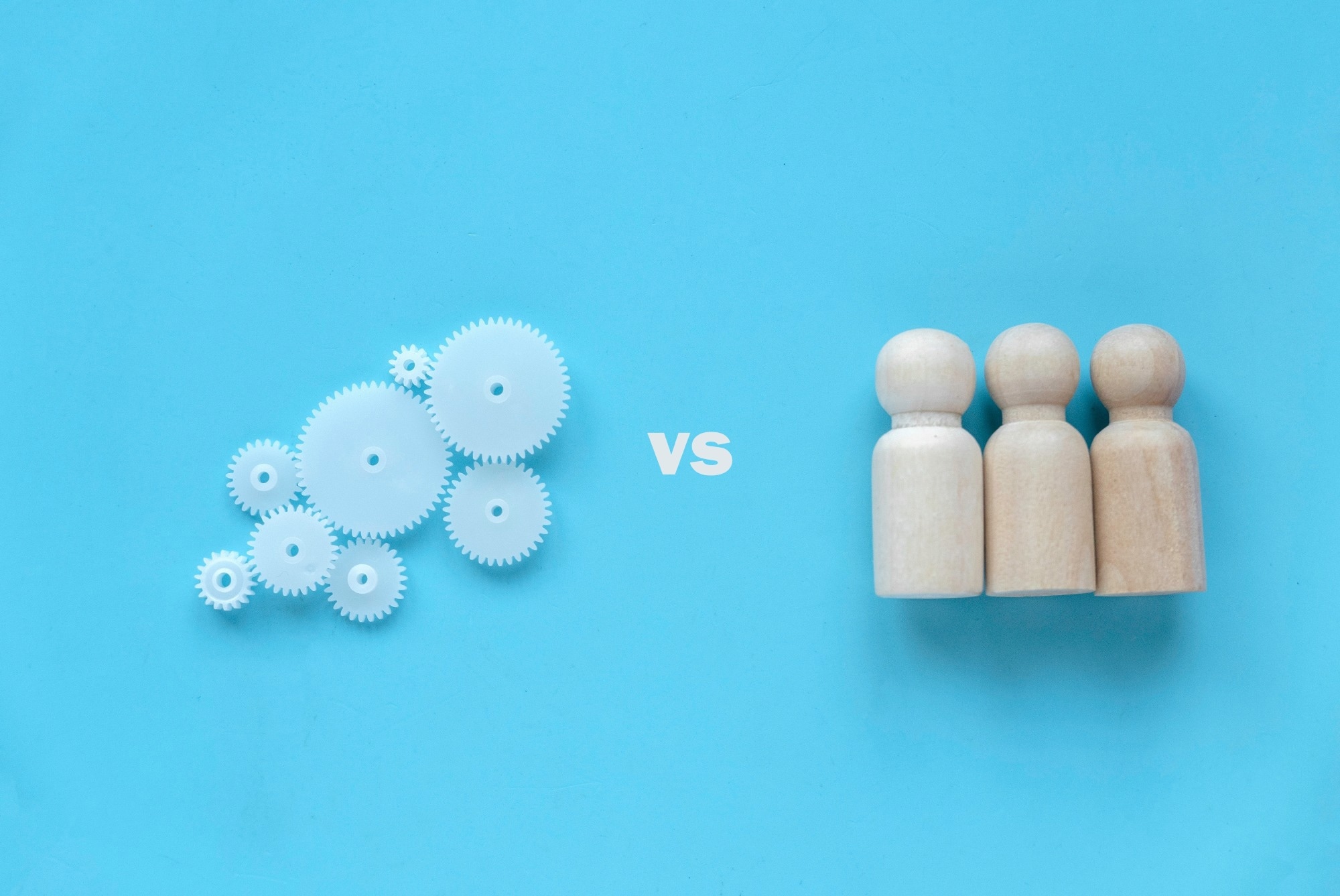 Human vs machine concept on a light blue background.