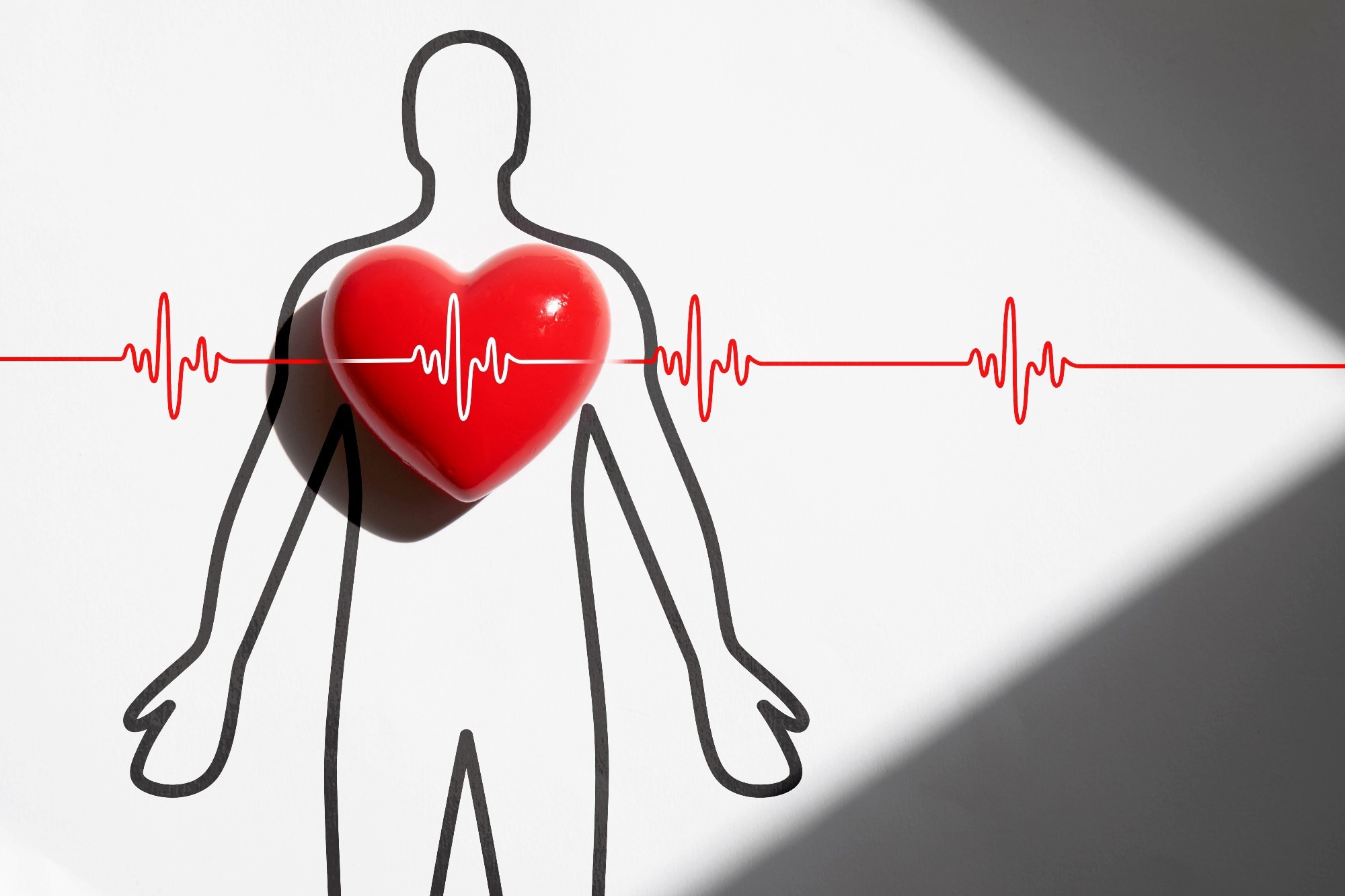 Red heart with a wave line drawing to represent a healthy functioning heart.