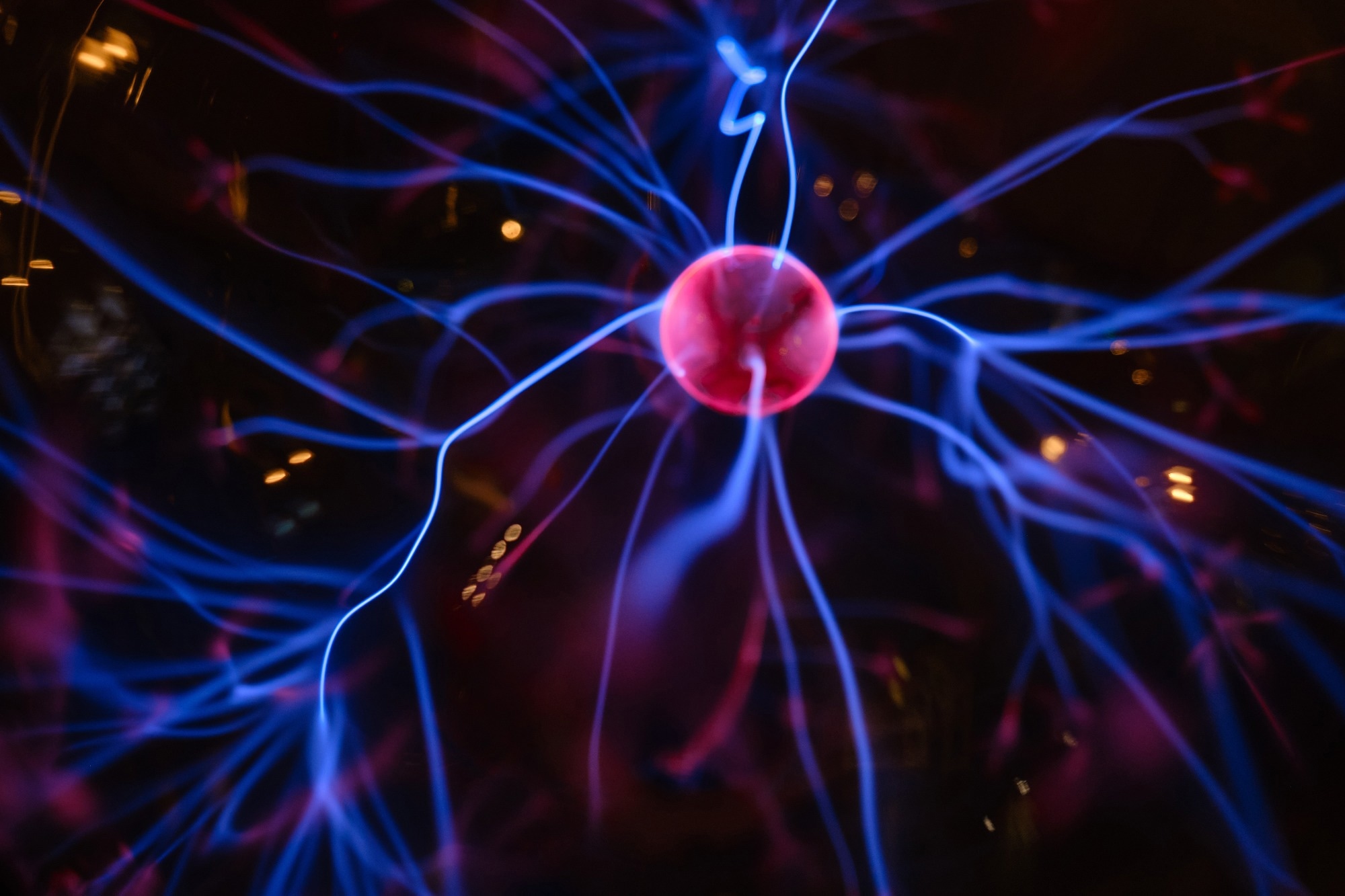 Abstract neuron background. Flashes of purple pink light on a dark background.