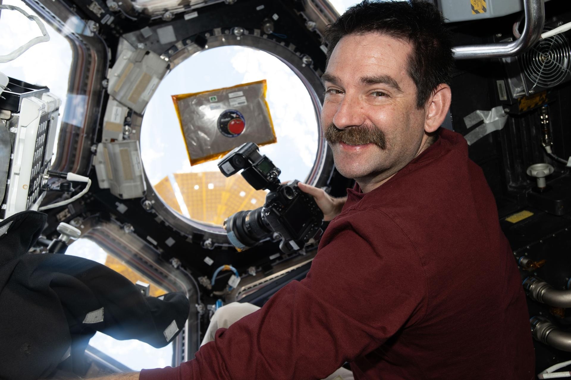 NASA astronaut Jack Hathaway smiles for a portrait inside the International Space Station’s cupola while photographing scientific hardware for a biomanufacturing experiment.