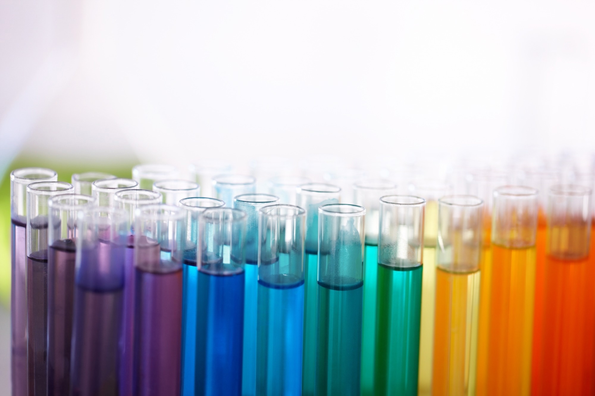 Multiple glass test tubes with different colored liquids