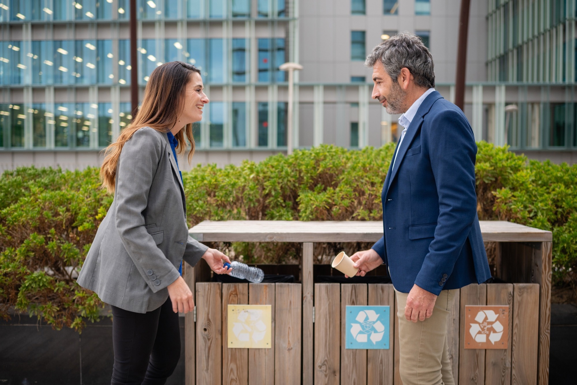Business coworkers recycling plastic bottle and paper cup