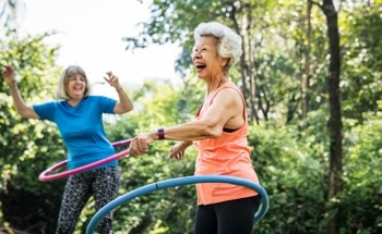 The Physics of Hula-Hooping: How Shape and Motion Keep the Hoop Spinning